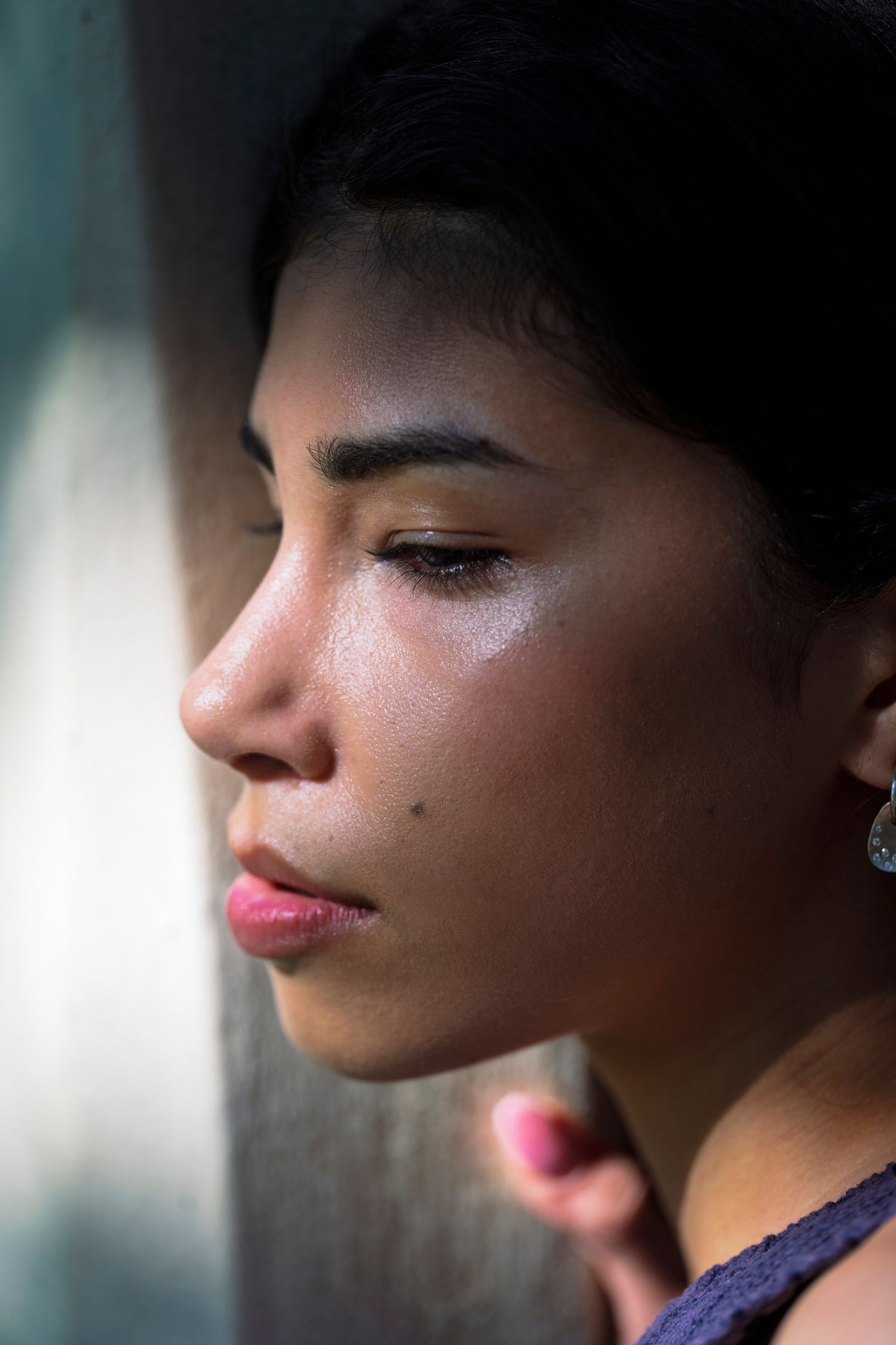 A young woman in soft natural light, calm and thoughtful