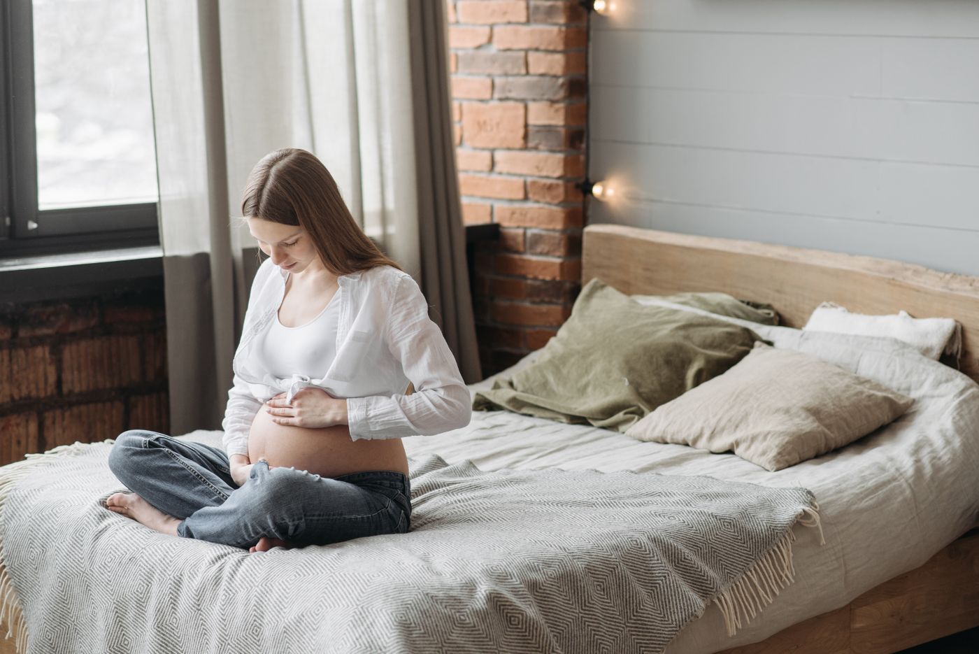 A pregnant woman sitting calmly in soft morning light